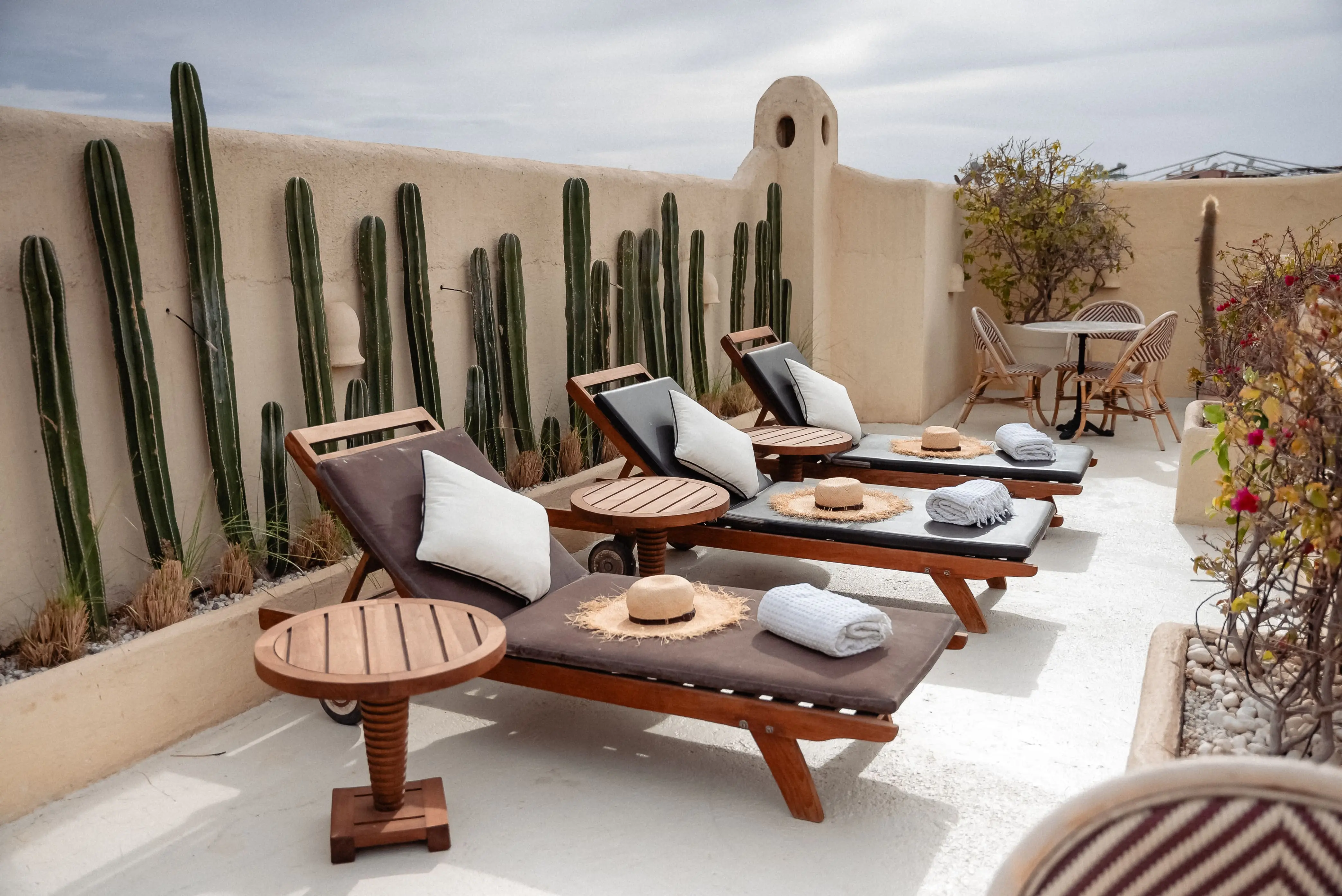 Balcony perspective overlooking the emerald swimming pool and courtyard greenery at Pure House Marrakech
