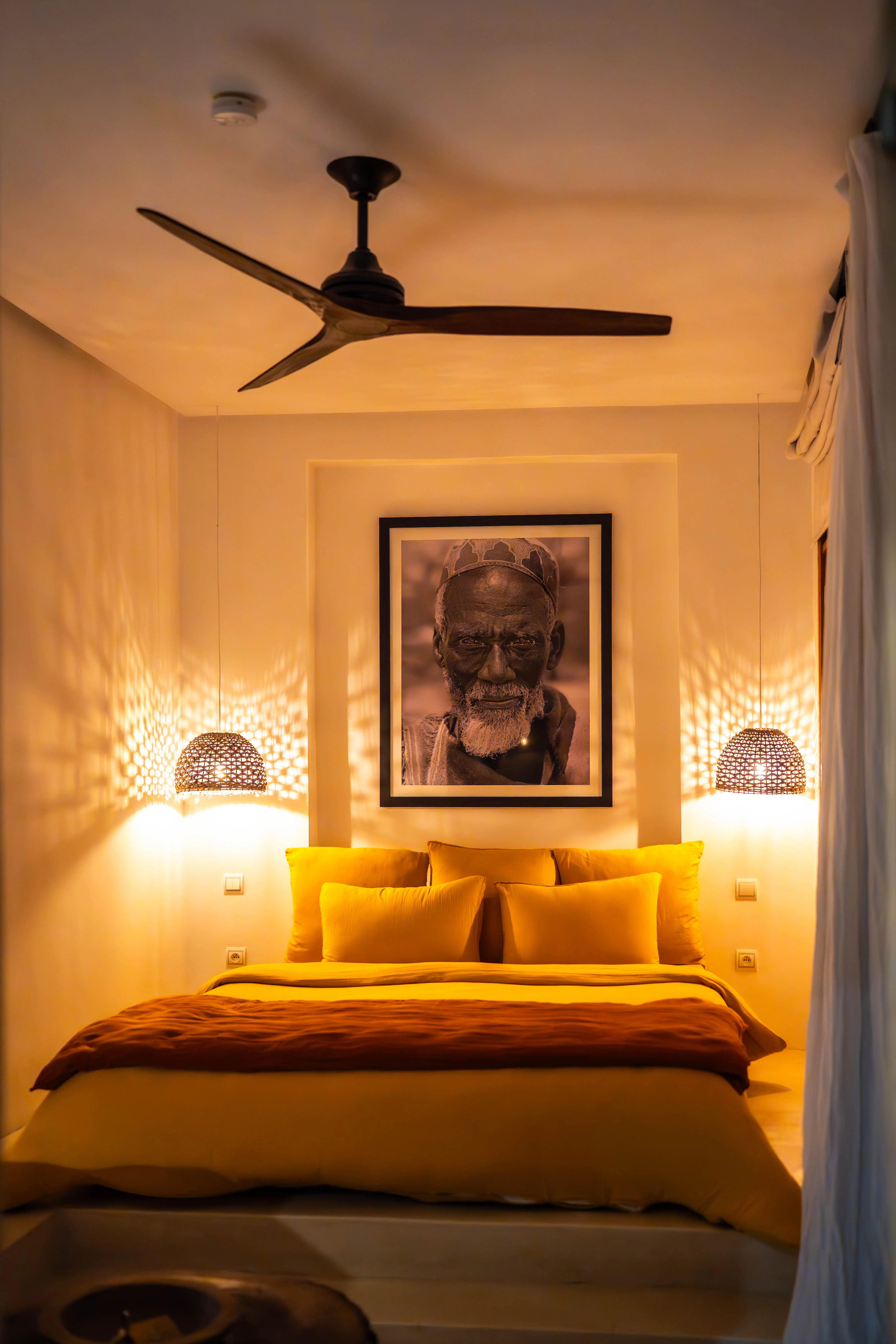 Warmly lit boutique hotel room at Pure House Marrakech, focusing on comfort and romantic aesthetics